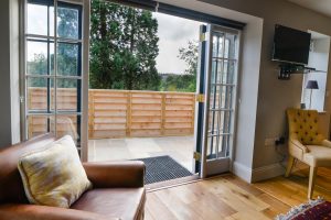 Double patio doors leading outside from living area at The Studio at Pensile House