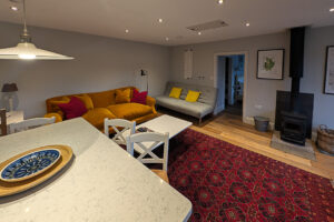 Lounge area with log burner at The Studio at Pensile House