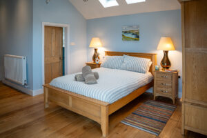 Master bedroom with double bed and ensuite at Carrek Cottage