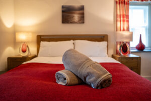 King sized bed in bedroom 2 at Carrek Cottage