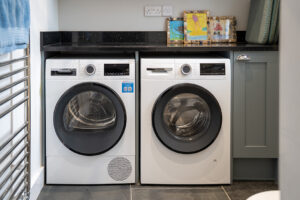 Washing machine and tumble drier in utility room at Carrek Cottage