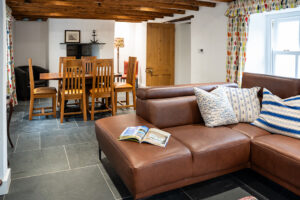Corner sofa in lounge/dining area, seating for six at Oak table at Carrek Cottage