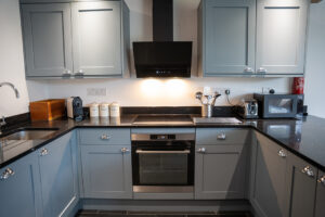 Fully equipped kitchen with integrated oven at Carrek Cottage