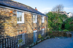 Front of property with railings and parking space at Carrek Cottage