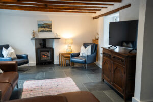 Lounge at Carrek Cottage, log burner and TV