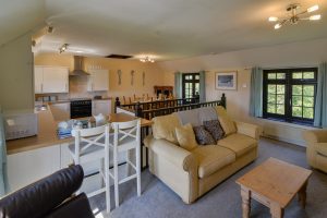 First floor open plan living area at Stable Cottage showing kitchen, dining and lounge areas