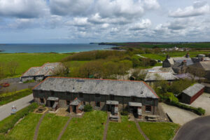 Aerial view of Stable Cottage and adjoining properties and view of the ocean and coastline