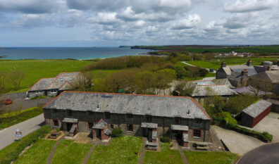 Aerial view of Stable Cottage and adjoining properties and view of the ocean and coastline