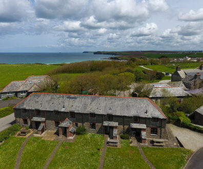 Aerial view of Stable Cottage and adjoining properties and view of the ocean and coastline
