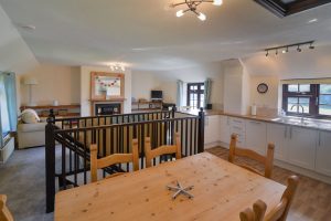 First floor open plan living area at Stable Cottage showing kitchen, dining and lounge areas