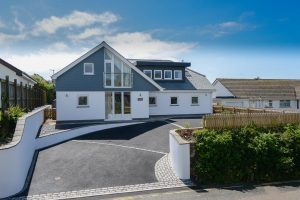 Front exterior with driveway into parking area at Trebriani