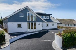 The front exterior and parking area at Trebriani