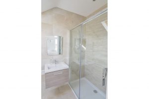 The shower cubicle and wash basin in the ensuite to the master bedroom at Trebriani