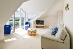 First floor lounge with large folding glass doors with juliet balcony