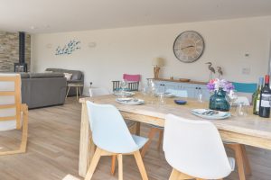 Dining table and chairs in the open plan living area at Trebriani