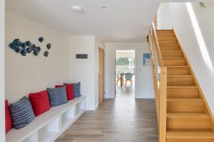 Entrance hallway with stairs and fitted seating at Trebriani
