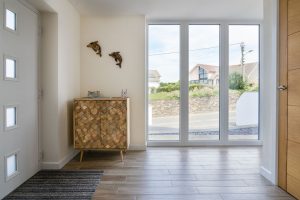 Large floor to ceiling window in the entrance area at Trebriani