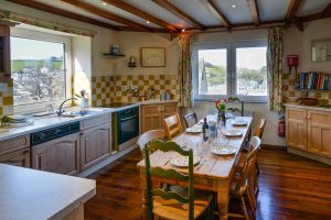 First floor Kitchen with dining table and views of Padstow at Granite House