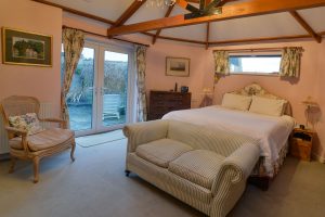 Large ground floor superking ensuite bedroom with double doors to patio