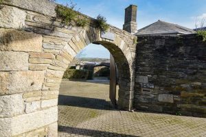 Stone archway into The Granite House from the road