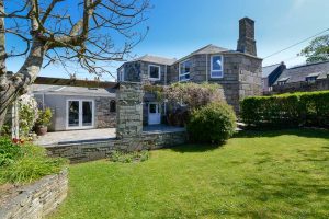 Exterior rear view of The Granite House with large grassed garden
