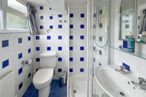 Ground floor bathroom with shower cubicle, toilet and basin