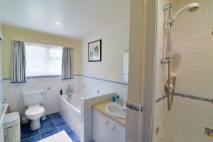 Ensuite to the master superking bedroom showing bath with hand held shower, shower cubicle, toilet and wash basin