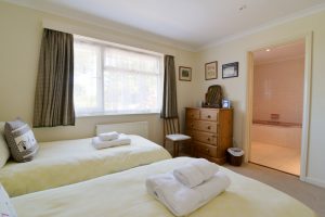 The second twin bedroom at Tamarisk with door into the shared ensuite
