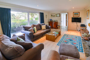 Lounge at Tamarisk with large window and door to the hallway