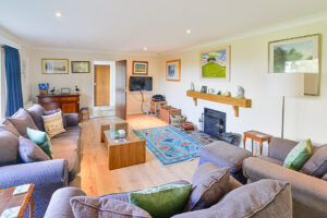 Lounge at with open fire at Tamarisk with door to the hallway