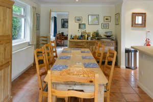 Dining table and chairs at Tamarisk with door into the lounge