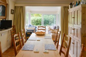 Dining area at Tamarisk leading into the garden room and doors to rear patio and garden