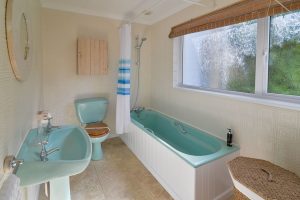 The master bedroom ensuite at The Ridings with bath, toilet and wash basin