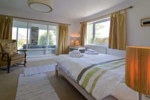 The master king ensuite bedroom at The Ridings with window into the entrance room and window to the side of the house