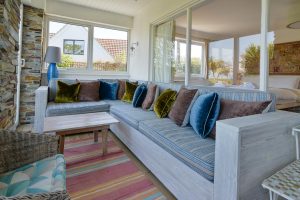 Sofa type seating in the entrance room at The Ridings with large window into the master bedroom