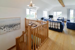 Staircase leading to first floor open plan lounge at Little Tremawr