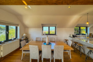 Large dining table for 8 with extra bar stool seating at Little Tremawr