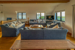 Ample seating in first floor lounge at Little Tremawr with TV