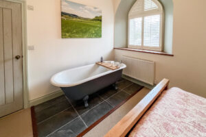 Free standing bath in king sized bedroom at Church House