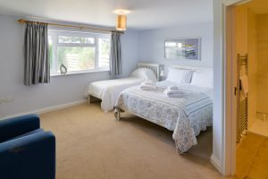 Ground floor King sized bedroom with additional single bed and ensuite at Little Tremawr