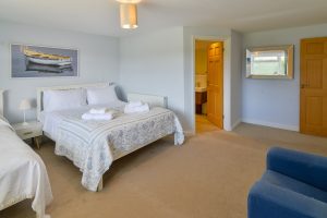 King sized ground floor bedroom with additional single bed and ensuite at Little Tremawr