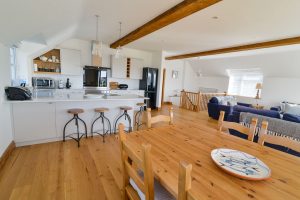Open plan first floor with kitchen, lounge and dining area at Little Tremawr