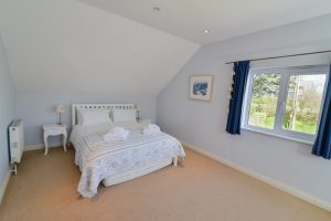 King sized bed on the first floor at Little Tremawr