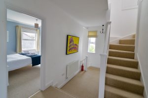 First floor hallway with stairs leading to the second floor at Newlands