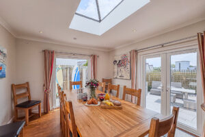 Dining area on the ground floor at Newlands with two sets of double doors leading to patio