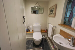 Cloakroom on the entrance floor with a toilet and basin.
