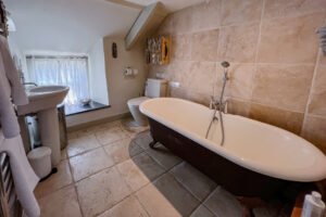 The bathroom with large bath and basin at Millingworth Mill