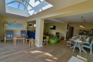 Ground floor open plan living space with sky lights at Rumah Panjang
