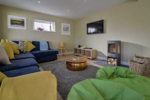Lounge at Rumah Panjang with log burner and mounted TV