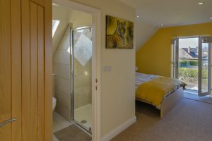 King sized bedroom with en suite bathroom on the first floor at Rumah Panjang